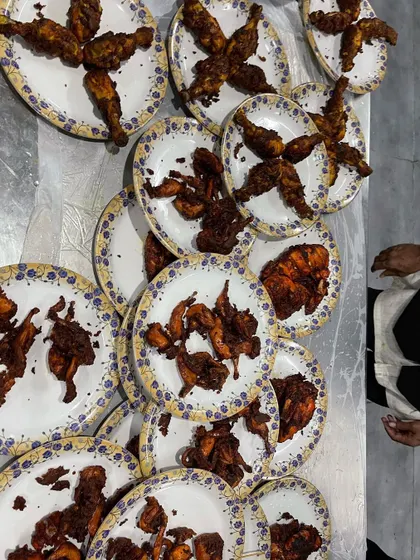 Preparing plates of our crispy fried chicken starters. We ensure each plate is arranged neatly, ready to be quickly served to hungry guests.