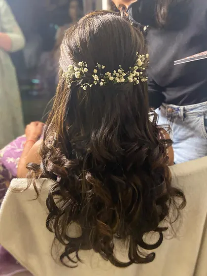 Another look at a half-up style with soft curls and a baby's breath hairpiece.
