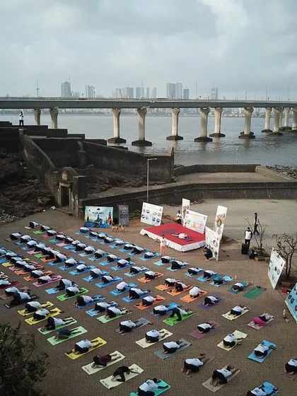 An aerial view of our Yoga Day celebration, capturing the beautiful symmetry of the practitioners against the stunning coastal backdrop of Mumbai.