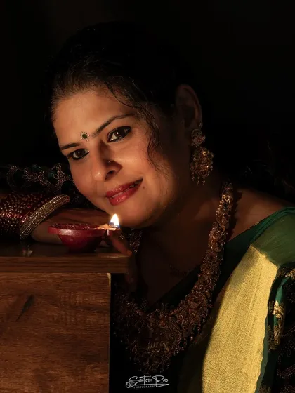 A candid moment from my Diwali photoshoot. The warm light from the diya beautifully illuminates the rich fabric of the saree.