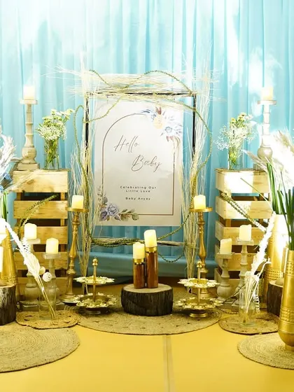 The welcome area for Avyay's baby shower, featuring a "Hello Baby" sign, pampas grass, and gold accents for a touch of glam.