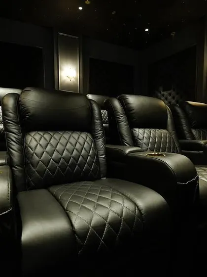 An intimate close-up of the diamond-stitched pattern on the leather recliners, showcasing the high-quality materials and craftsmanship I use in my projects.