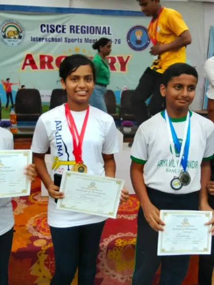 Our archers proudly displaying their medals and certificates. Each win is a team effort, reflecting the supportive community we've built.