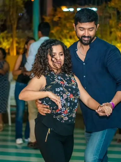 A couple completely in sync, enjoying the music and each other's company. This is what partnership in dance looks like.