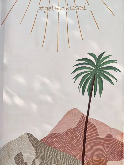 The top section of the mural, featuring a stylized sun and the hashtag #getsunkissed.