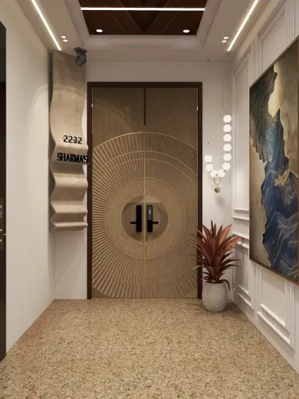 This Noida penthouse entryway embodies luxury, with a stunning carved door featuring metal profiles and a custom flare-pattern nameplate.