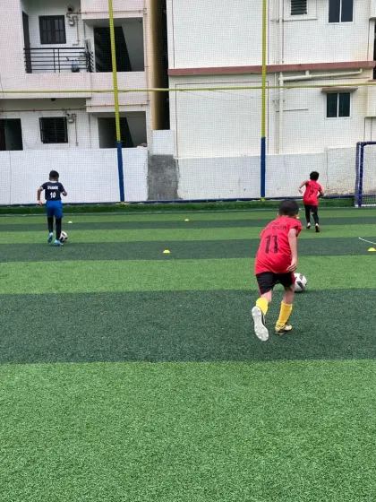 Young players navigating a cone drill, honing their agility and ball-handling skills.
