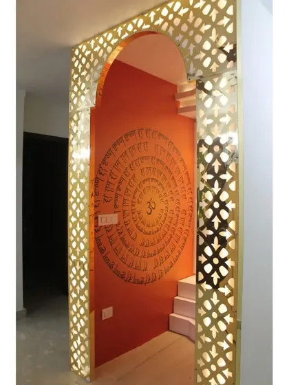 The other side of the mandir room features a large 'Om' mandala wallpaper, creating a complete spiritual space.
