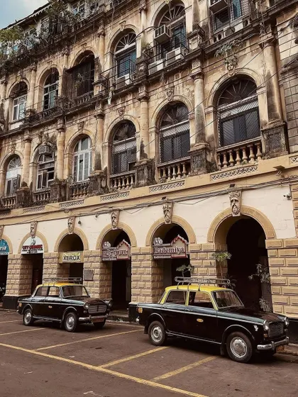 The classic 'Kaali Peeli' taxis parked outside our Fort restaurant. A timeless Bombay scene. We cherish the memories of customers arriving in these iconic cabs for decades.