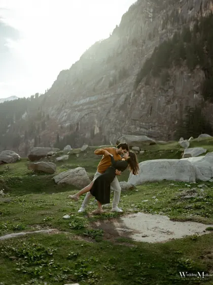 A joyful, cinematic dip against the majestic mountains of Manali. We love creating dynamic, movie-like shots that capture the energy and passion of our couples.