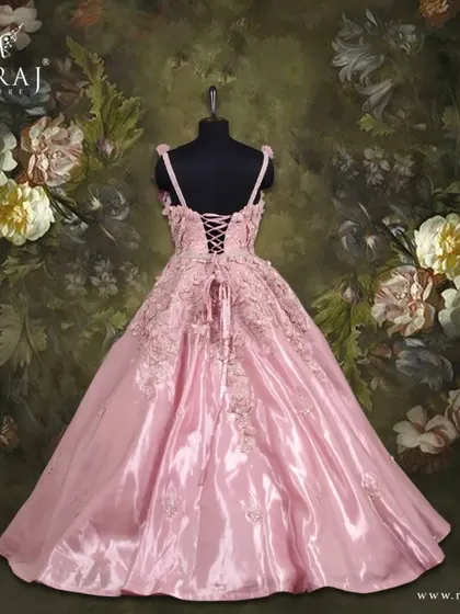 The back view of the peach gown, highlighting its beautiful design and lace-up detail.