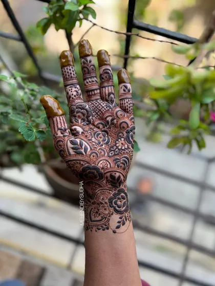 A creative shot of the single-hand design, held up against a natural background.