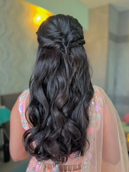 A simple and elegant half-updo with a twisted detail, a classic look for any occasion.