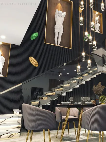 The double-height staircase with its glass railing and sculptural lighting becomes a central feature in this dining area, adding a sense of grandeur and openness.