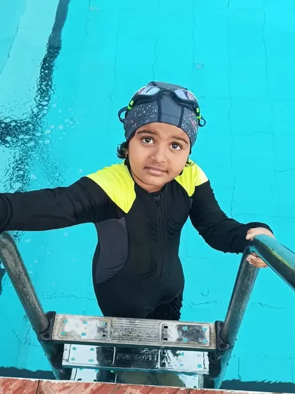 A student gets ready to exit the pool after a challenging practice session.