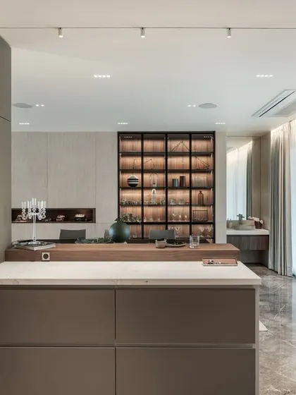 From the kitchen, one can look out into the dining and living areas. This open-concept design ensures that the person cooking is still part of the home's social life.