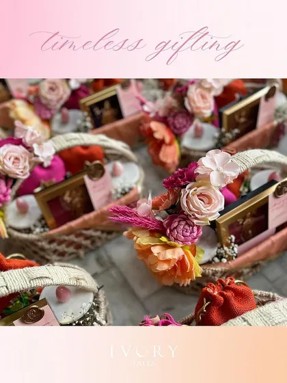 A full view of the engagement favor baskets, arranged to show the scale of the order. The vibrant pink and orange floral arrangements make for a stunning visual.
