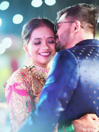 A joyful embrace between the couple during their engagement celebration, filled with genuine happiness.