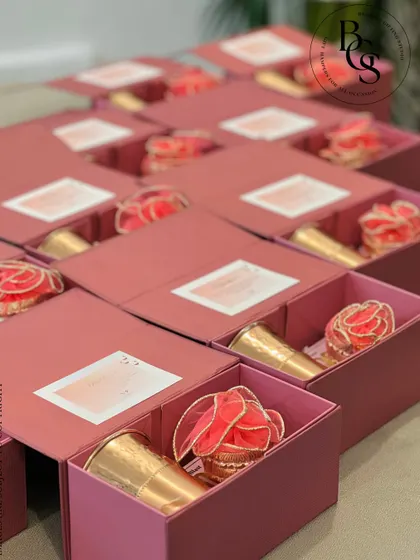 These drawer-style boxes in a lovely rose colour are a sophisticated choice for return gifts. They can be filled with small keepsakes or treats, and the box itself becomes a cherished item.