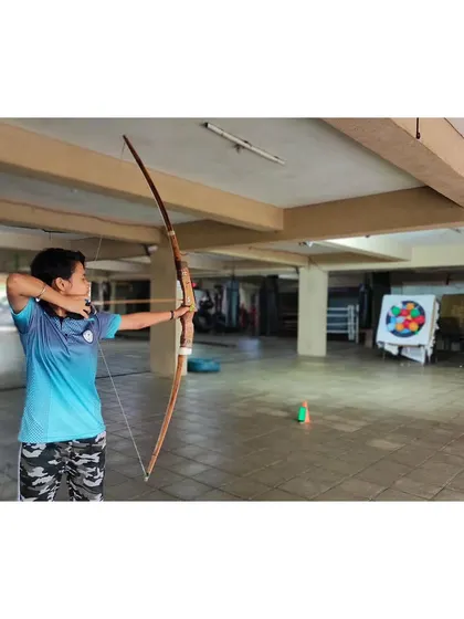 This archer shows a strong and stable posture, which is fundamental to powerful and accurate shooting.