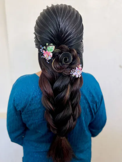 A closer look at the detailed hair rose and the delicate butterfly accessories. The highlights in the hair add dimension to this creative style.