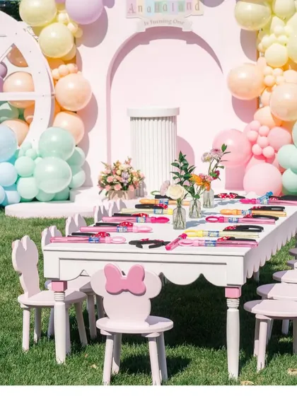 The beautifully set kids' table, with themed chairs and a view of the main pastel backdrop.