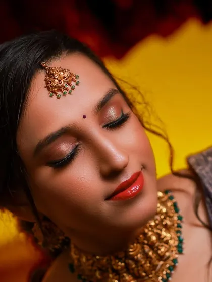 A close-up of the bride's serene expression, highlighting her beautiful makeup and traditional jewelry.