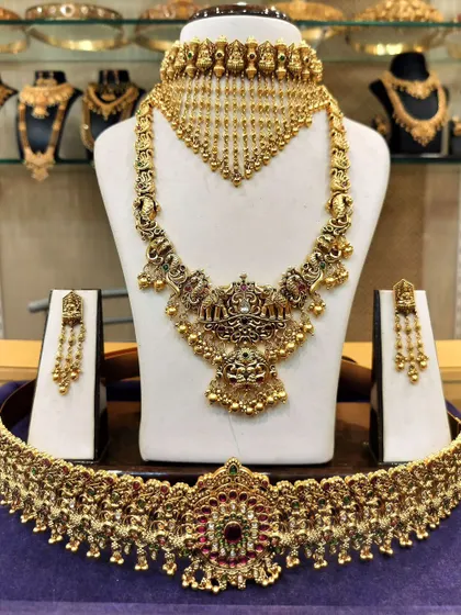 A complete bridal set featuring a unique choker with a hanging chain design and a matching long haram.