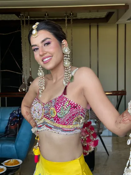 A happy Haldi bride! The makeup is designed to be picture-perfect, with a flawless base and eyes that pop.