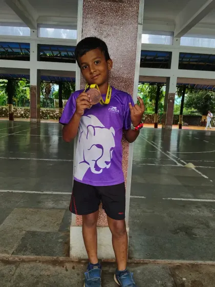 A young champion from our academy proudly displays his bronze medal after the 100m race at the CISCE zonal championship.