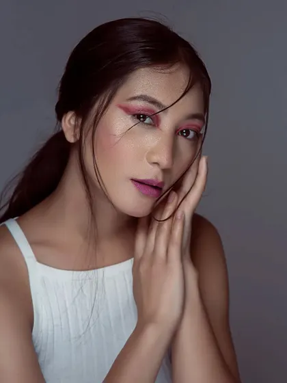 A final portrait from the creative pink makeup series, showing a clean, sharp look. The simple styling and pulled-back hair ensure the makeup artistry is the hero of the image.