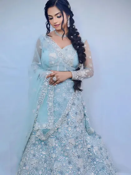 A full view of the light blue lehenga with intricate silver embroidery, a stunning choice for an engagement or sangeet.