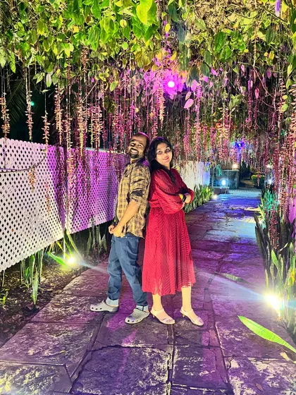 Another romantic shot of a couple at our Ramanagara resort, enjoying the magical ambiance of the illuminated pathway.