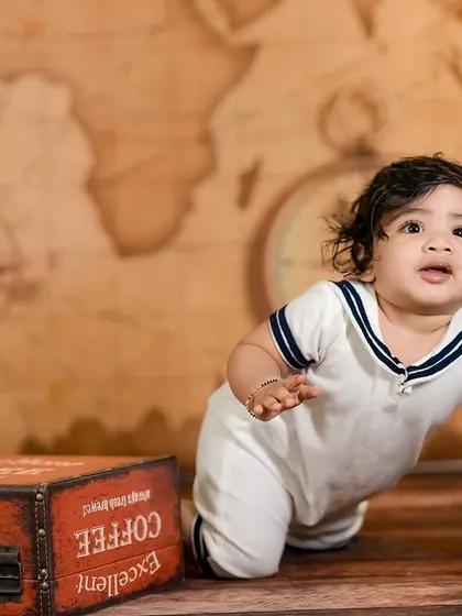 A crawling baby adventurer in our travel-themed setup. We capture their journey of exploration and discovery.