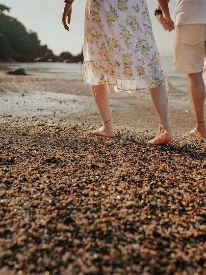 Walking hand-in-hand along the shore. This detail-oriented shot focuses on the simple act of being together, a beautiful memory from a destination pre-wedding adventure.