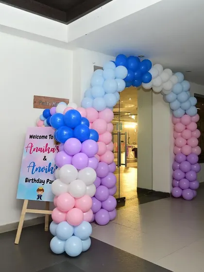 An entrance setup for a princess-themed party with a colorful balloon garland.