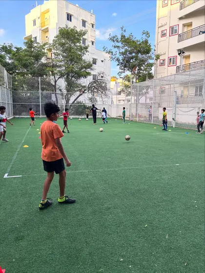 A young player watches the game unfold, learning strategy and positioning. We focus on developing smart, thoughtful players.