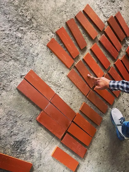 On-site selection of brick samples. We carefully consider the exact color and texture, laying them out to see how they interact with the light and surrounding environment before making a final choice.