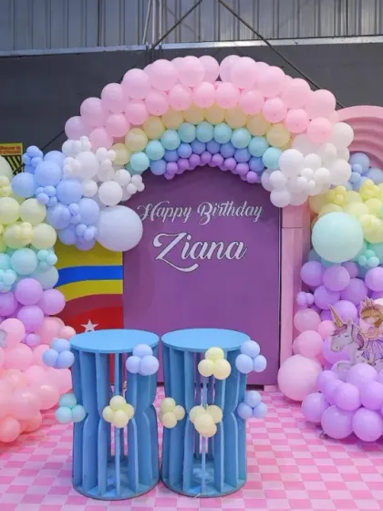A beautiful unicorn and rainbow-themed birthday setup for Ziana. The pastel colors, cloud-like balloons, and unicorn figures create a truly enchanting atmosphere.
