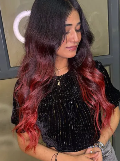 This plum red balayage is all about rich, deep tones. The color is bold yet sophisticated, and the waves add incredible volume and movement.