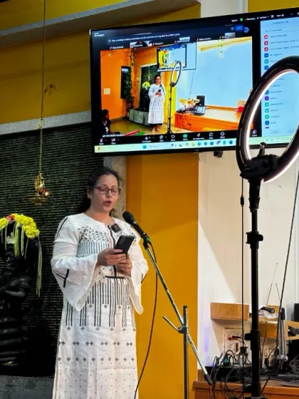 A participant asking a question during the Q&A portion of a Yoga Vichara talk.
