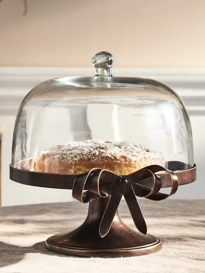 A charming cake stand with a glass dome, styled with a freshly baked cake. This shot is perfect for kitchenware or decor, creating a warm, homely, and aspirational feel.