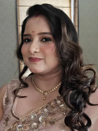 Party makeup with a focus on glowing skin and shimmery eyes. This look is perfect for guests who want to look polished and festive.