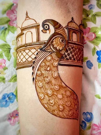 The peacock arm band design after the filling and shading has begun. The contrast between the outline and the detailed fill creates a striking effect.