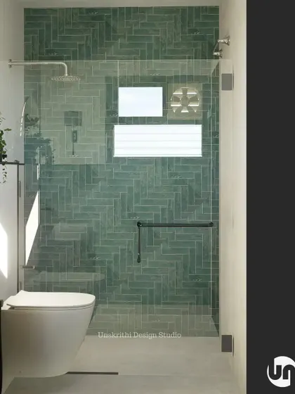 A closer look at the herringbone pattern and aqua subway tiles in this shower design. The frameless glass partition keeps the space feeling open, while the dark fixtures provide a modern contrast. It's a simple mood check that delivers a big impact.