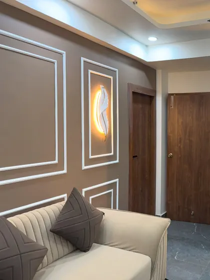 A close-up of a feature wall in a living room. I used simple POP moulding and a backlit feather art piece to create an elegant and calm corner.