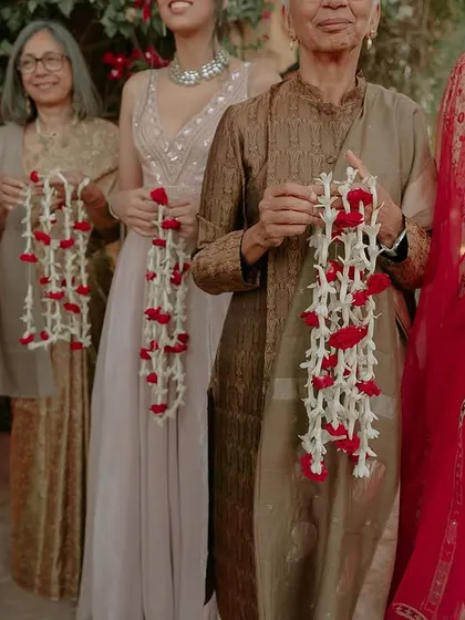 Family and friends holding traditional garlands, ready to welcome the grooms. We ensure that every guest feels like a part of the celebration, weaving together traditions and personal touches to create a cohesive and heartfelt experience.