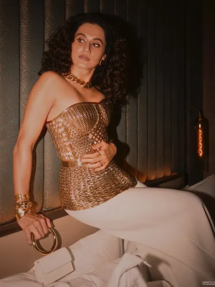 A moody, atmospheric shot of Taapsee Pannu in a golden corset and my statement bangles. This is what I call main character energy.