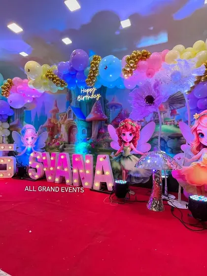 The fairyland stage illuminated with colorful lights, highlighting the different fairy characters and the magical castle in the background.