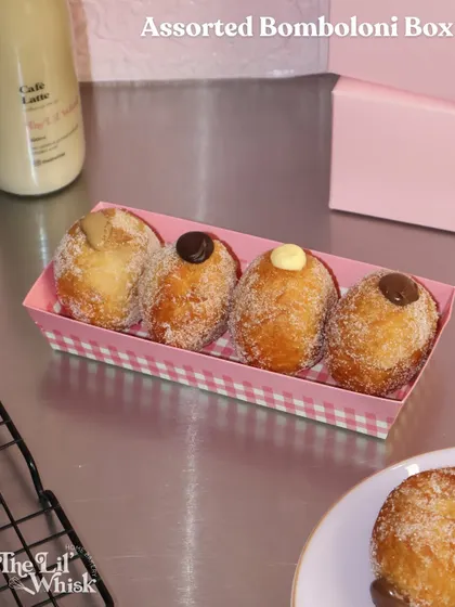Our assorted bomboloni box is pure happiness. These fluffy Italian doughnuts are rolled in sugar and filled with delicious creams like Nutella, vanilla custard, and more.